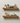 Pack of 2 walnut floating shelves, wall-mounted in a modern living room