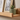 a side view of a wooden picture ledge displaying home decor accessories.